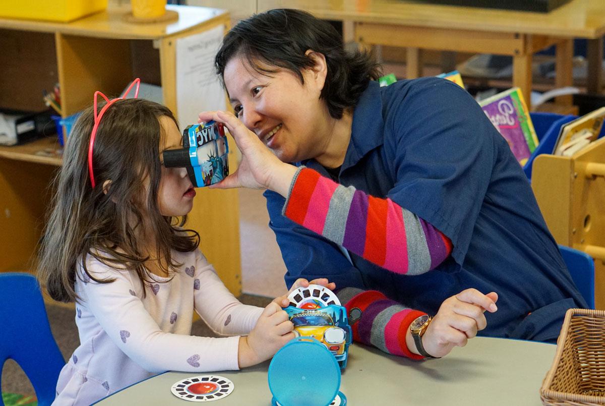 Child interacting with a teacher.